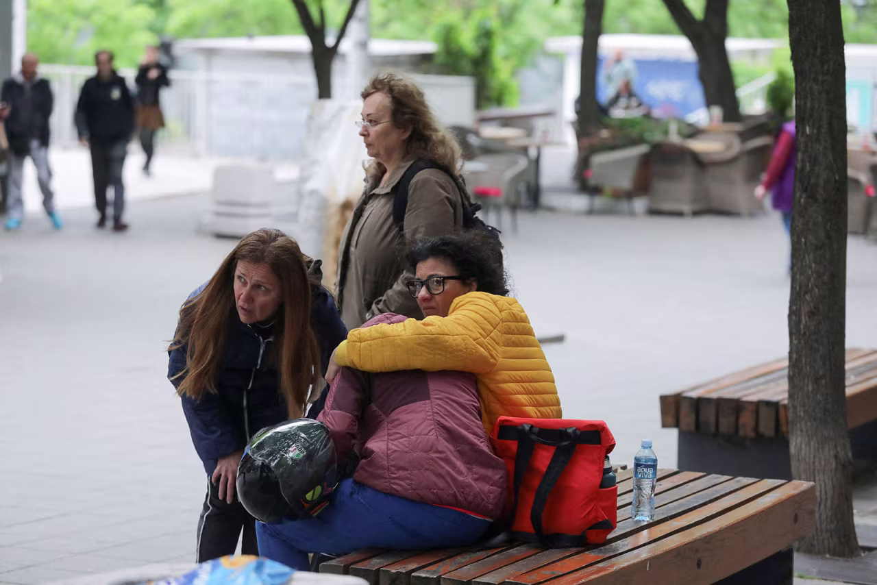 People react after students were shot at a school in Belgrade, Serbia, on May 3. 