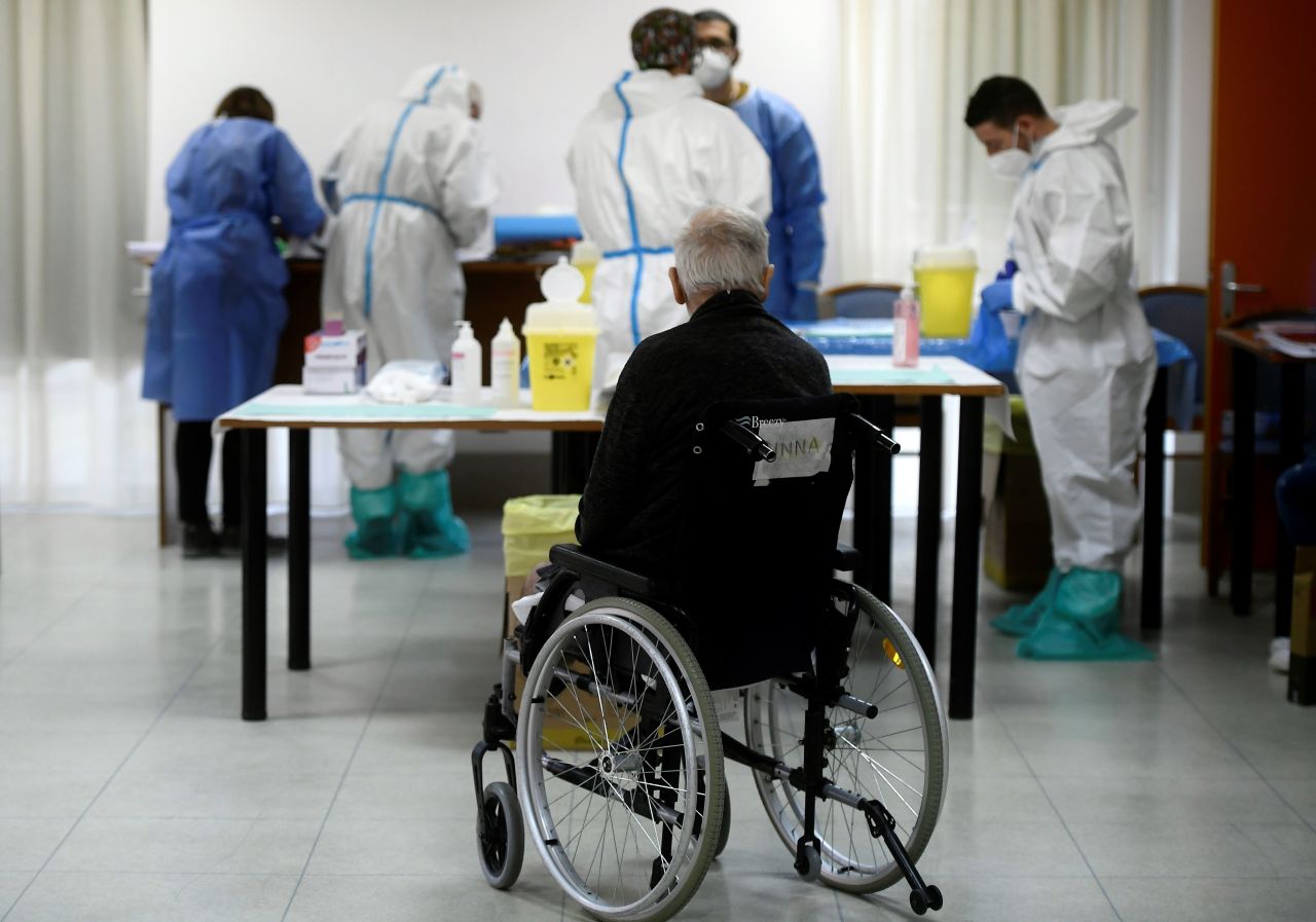 A resident of a care home in Rome waits to receive a dose of the Pfizer-BioNTech COVID-19 vaccine on January 8. 