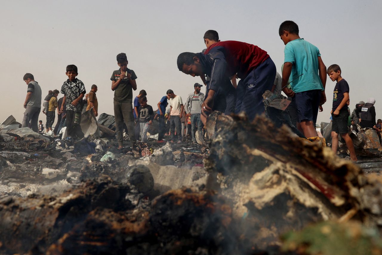 Palestinians gather on Monday at the site of an Israeli strike in Rafah.