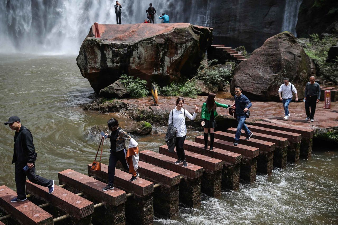 People visit Chishui Danxia Tourist Area in the Guizhou Province of China on April 24.