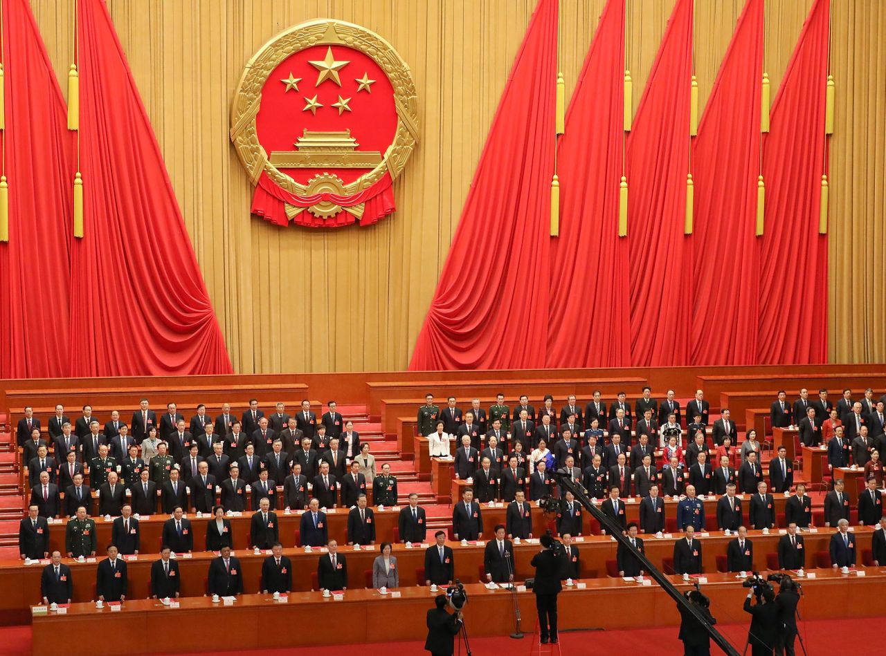 Chinese President Xi Jinping and the other attendees of the fourth and last Plenary Meeting of the National People's Congress stand and listen to the National Anthem at The Great Hall Of The People on March 15, 2019 in Beijing.