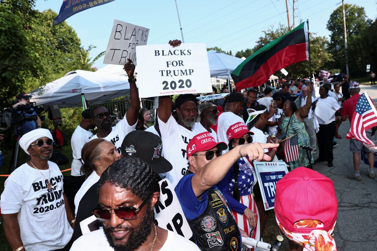 Supporters of former President Donald Trump hold banners at the entrance of the Fulton County Jail in Atlanta on Thursday.