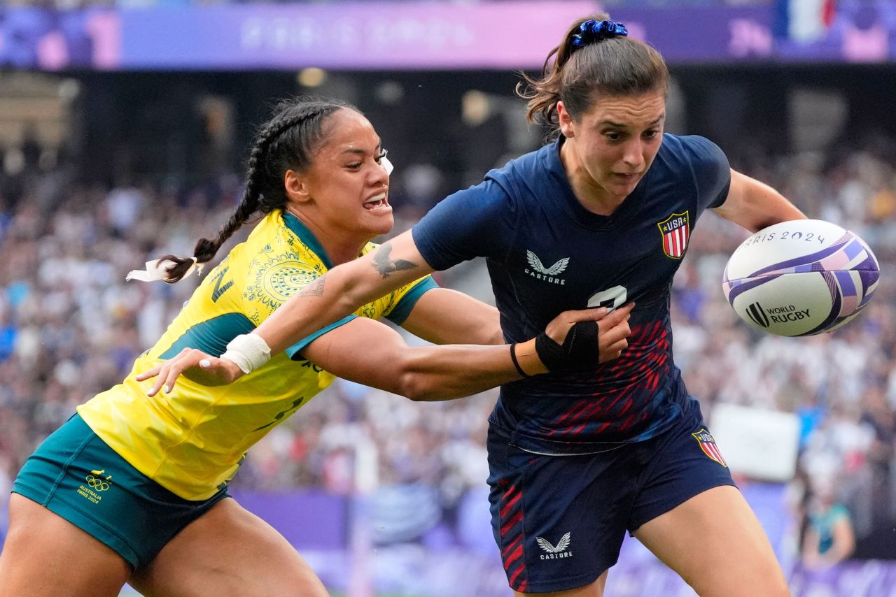 Kayla Canett of the United States runs with the ball against Australia's Faith Nathan on Tuesday.