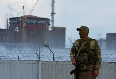A serviceman with a Russian flag on his uniform stands guard near the Zaporizhzhia nuclear plant on August 4. 