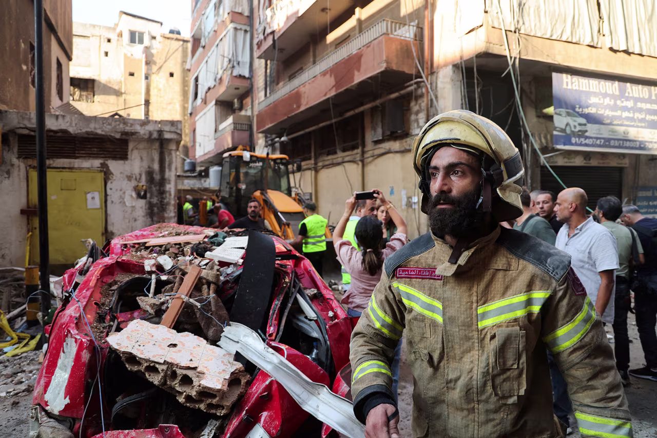 A firefighter works at the site of an Israeli strike, in Beirut's southern suburbs, Lebanon, on September 24.