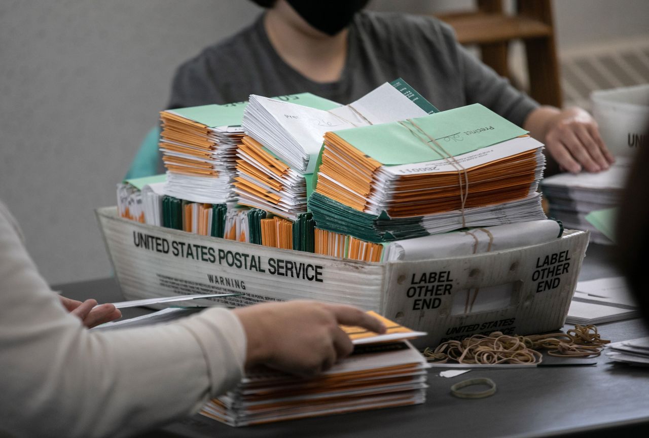 Election workers sort absentee ballot envelopes at the Lansing City Clerk's office on November 2 in Lansing, Michigan. 