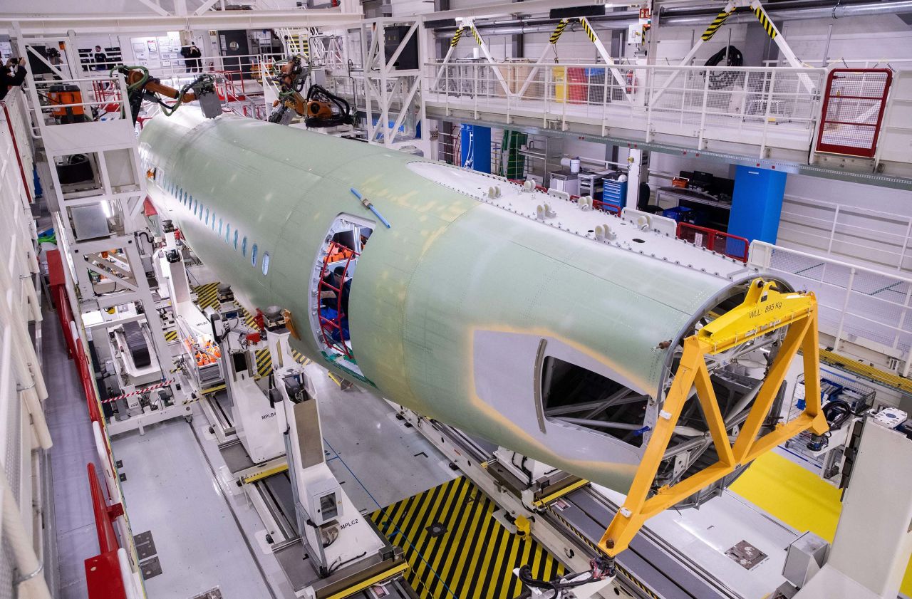 Airbus technicians work on parts for an Airbus A320 at the company's Finkenwerder plant in Hamburg, Germany, in October 2019.