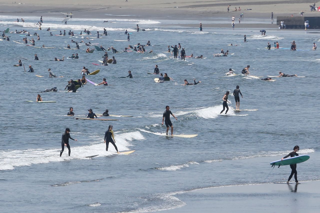 People surf off Katase-kaigan beach in Fujisawa, Kanagawa prefecture, near Tokyo, on Monday, June 8.