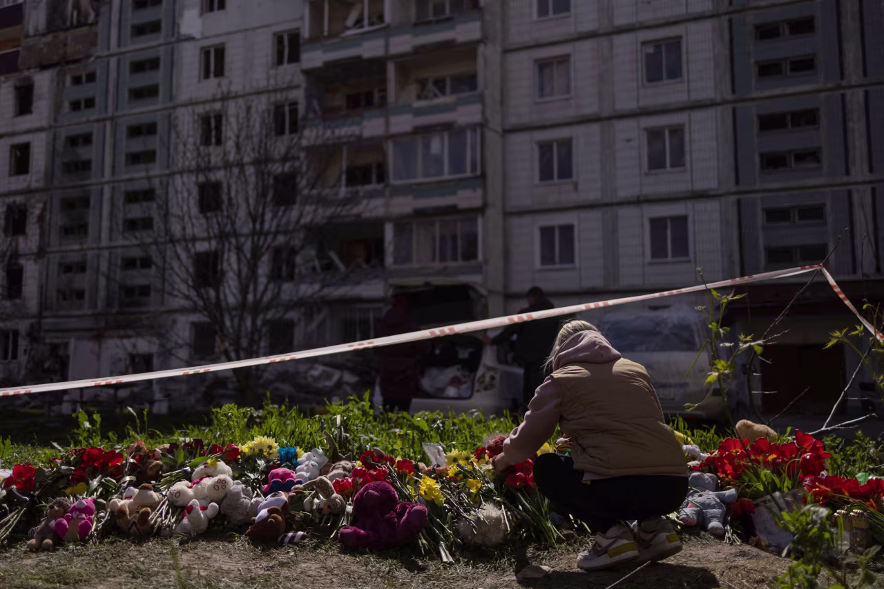 A woman pays tribute to civilians killed by a Russian missile strike in Uman, Ukraine, on April 29. 