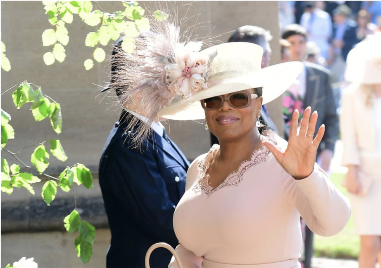 Oprah Winfrey wore a 70s inspired wide-brimmed hat by Philip Treacy.