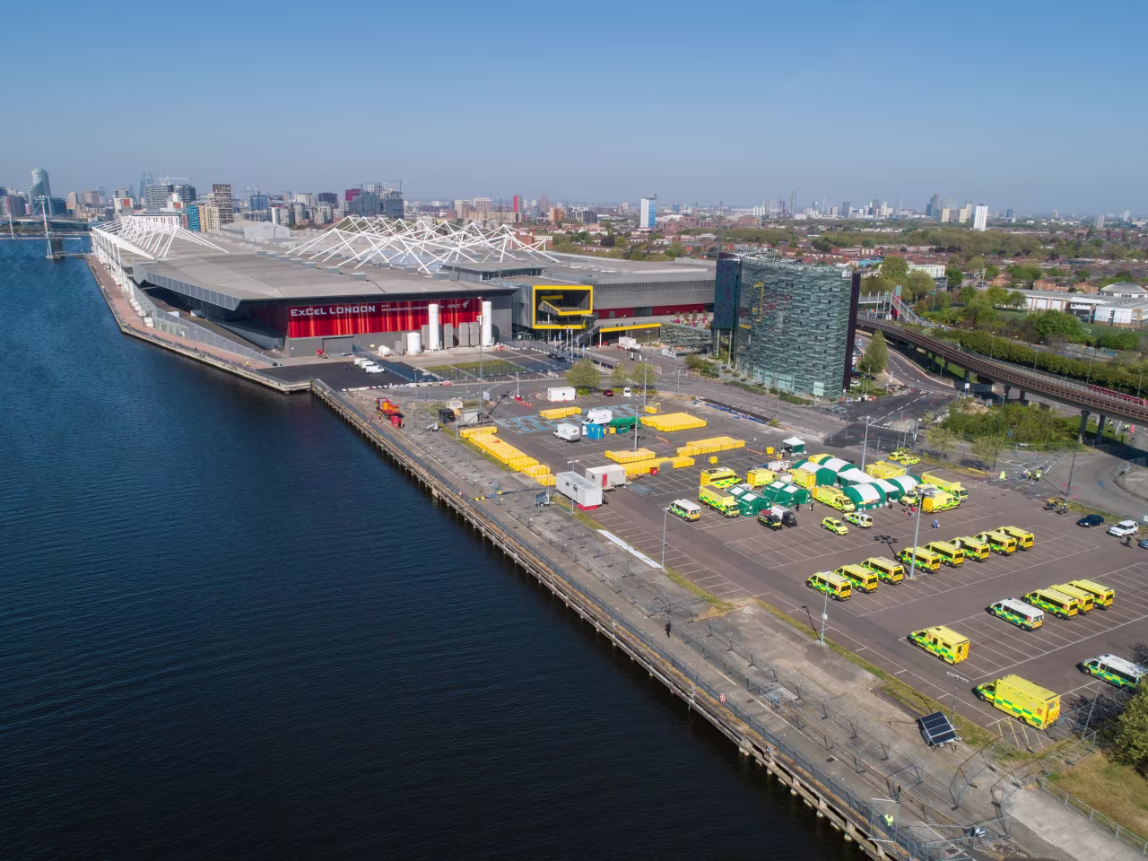 Emergency response vehicles sit parked outside London's ExCel conference center, which has been converted into an NHS Nightingale hospital to deal with the coronavirus pandemic, in this aerial view on Wednesday.