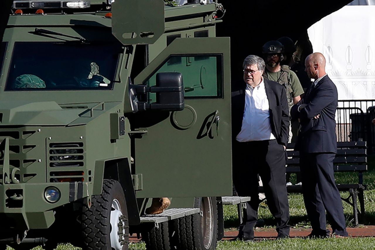 Attorney General William Barr, center, stands in Lafayette Park across from the White House as demonstrators gather on Monday, June 1, in Washington. 