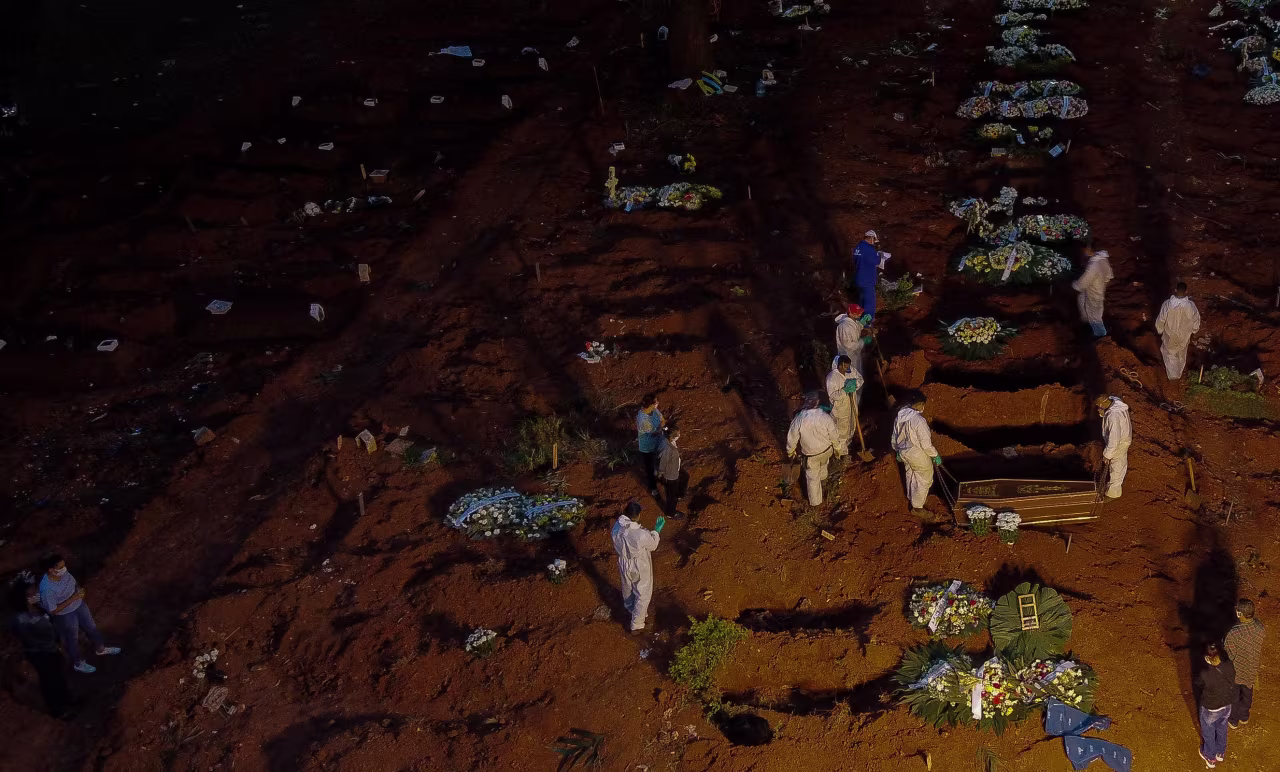 Workers bury a coffin at the Vila Formosa cemetery in Sao Paulo, Brazil, on April 17.