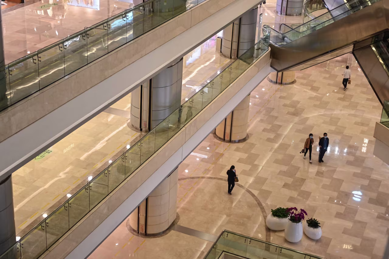 People are seen in a Wuhan shopping mall as the city tries to go back to business after lockdown on April 18.
