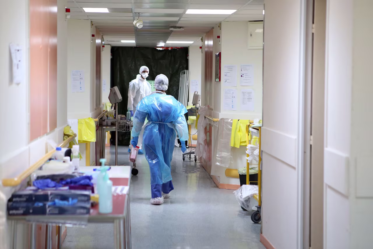 Nurses wearing protective gear walk in a hallway at a hospital in Ajaccio, France, on April 23.