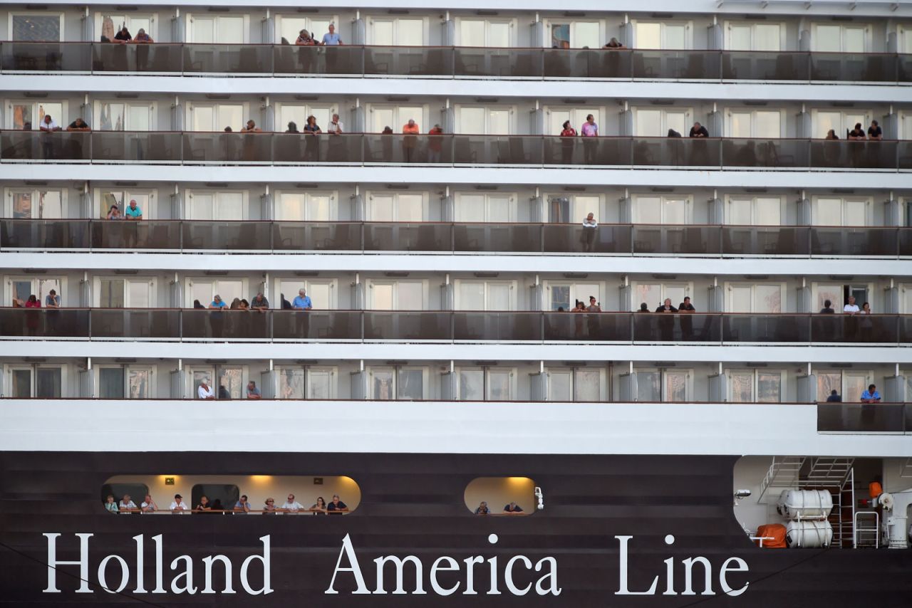 Passengers watch as the Westerdam cruise ship arrives at the port in Sihanoukville on Cambodia's southern coast on February 13.