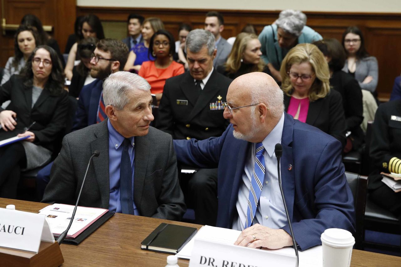 Dr. Anthony Fauci, left, director of the National Institute of Allergy and Infectious Diseases, speaks with Dr. Robert Redfield, director of the Centers for Disease Control and Prevention, before testifying at a House Oversight Committee hearing on the coronavirus outbreak in Washington, D.C. on Wednesday.