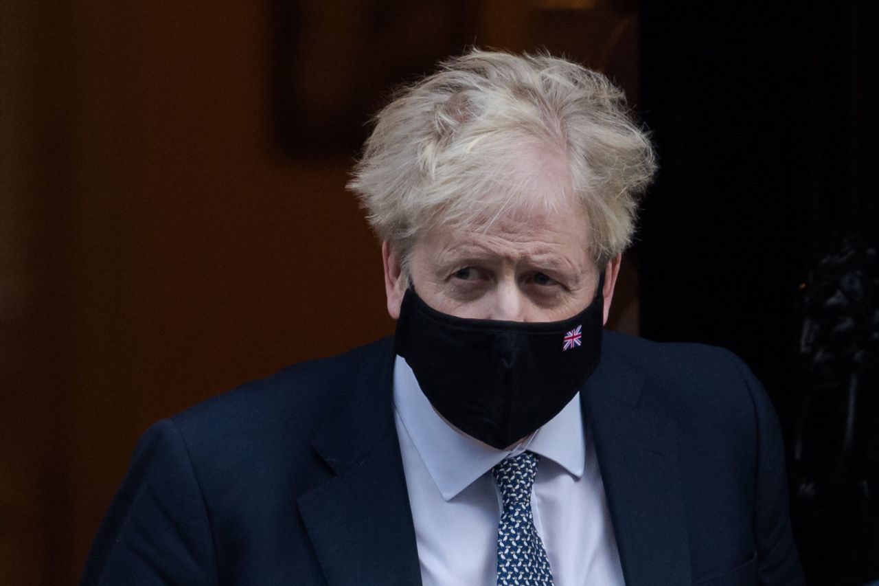 British Prime Minister Boris Johnson leaves 10 Downing Street for PMQs at the House of Commons on January 12 in London.