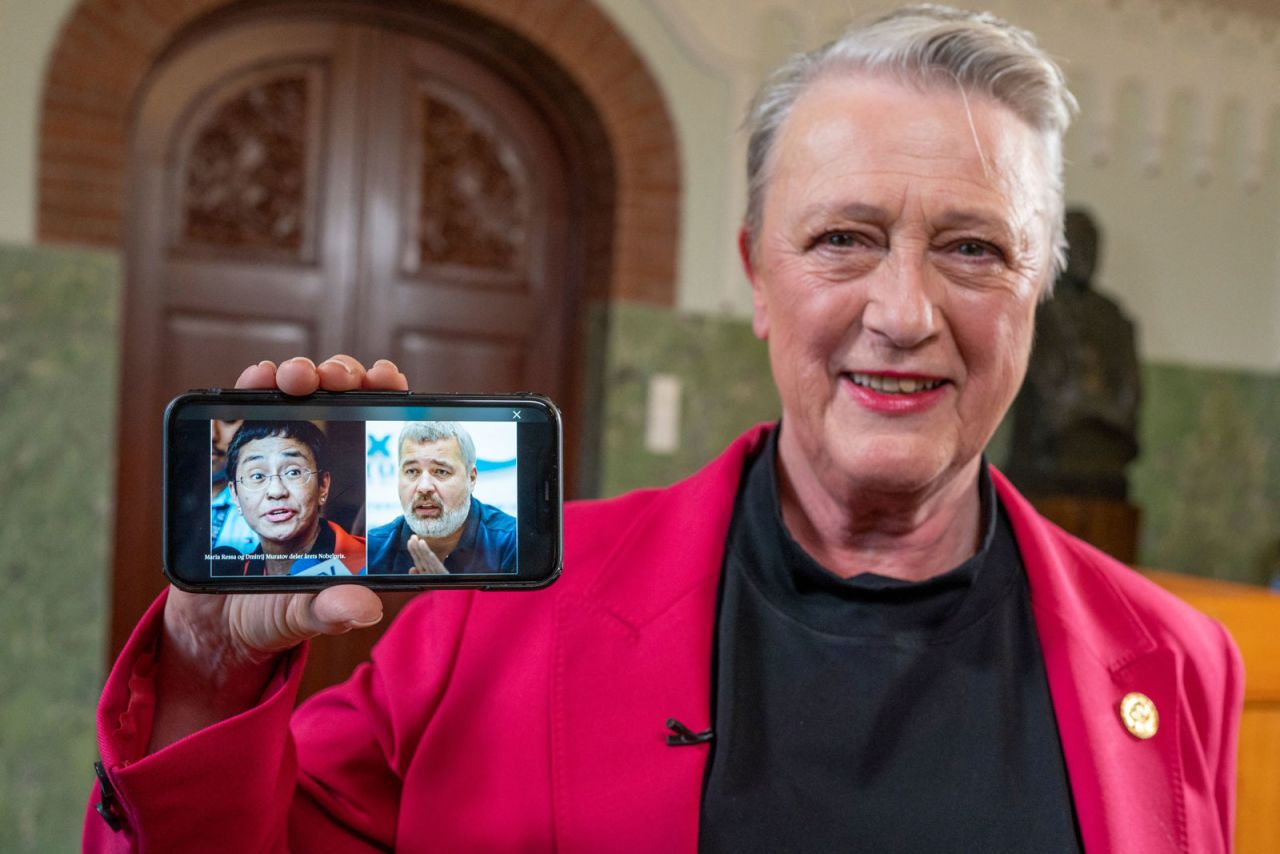 Berit Reiss-Andersen, chair of the Nobel Peace Prize Committee, presents a mobile phone displaying photos of journalists Maria Ressa and Dmitry Muratov following a press conference to announce the winners of the 2021 Nobel Peace Prize.