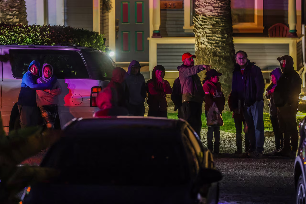 People embrace at the scene in Half Moon Bay, California on Monday, January 23.
