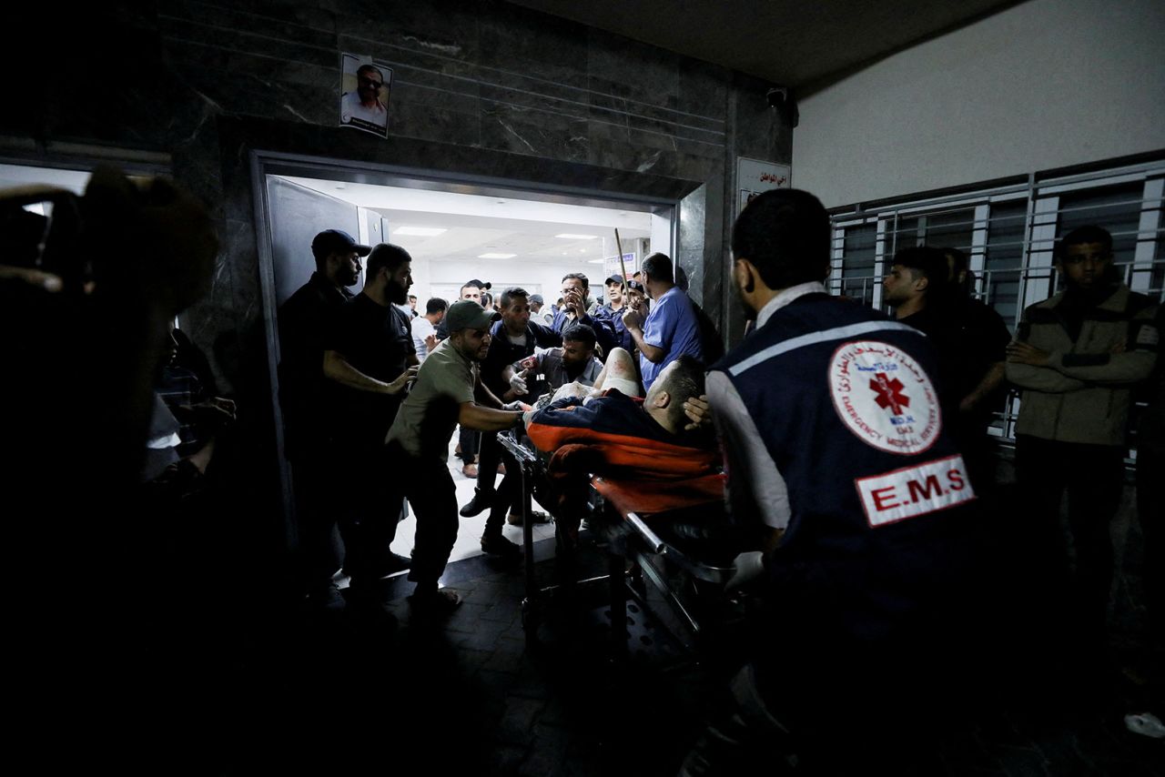 An injured person is assisted by medical personnel at the Al-Shifa Hospital in Gaza City.