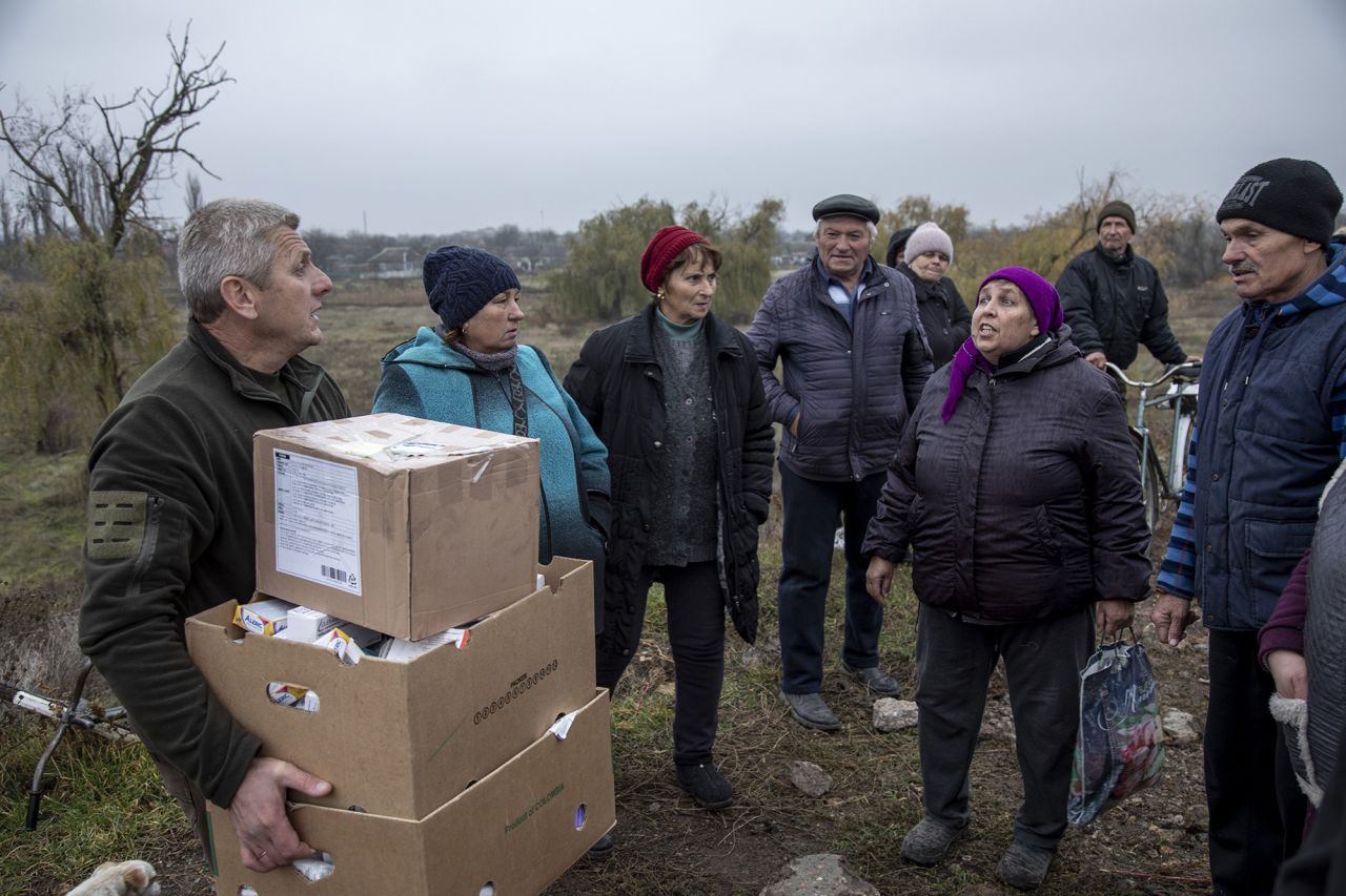 An aid worker delivers medicine to locals near Novopetrivka, following the withdrawal of Russian troops from Kherson region, Ukraine, on November 17.