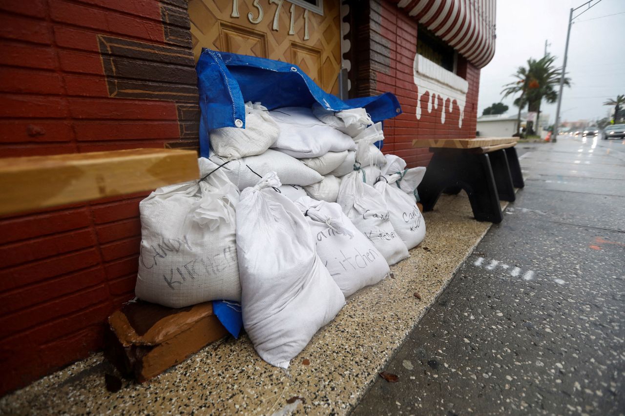 Sandbags are placed in front of the entrance to a candy shop in Madeira Beach, Florida, on August 4. 