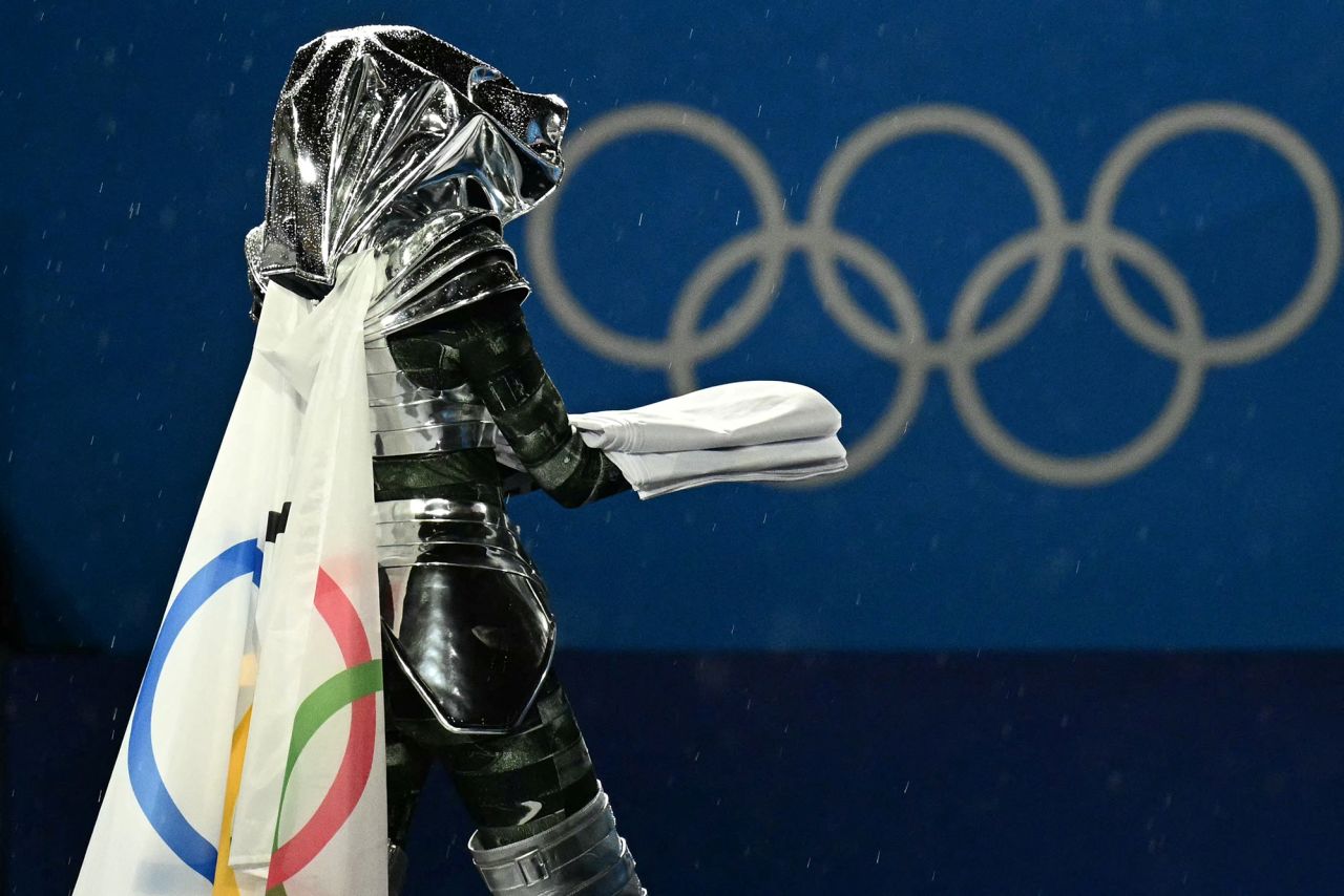 Floriane Issert, a Gendarmerie non-commissioned officer of the National Gendarmerie, carries the Olympic flag.