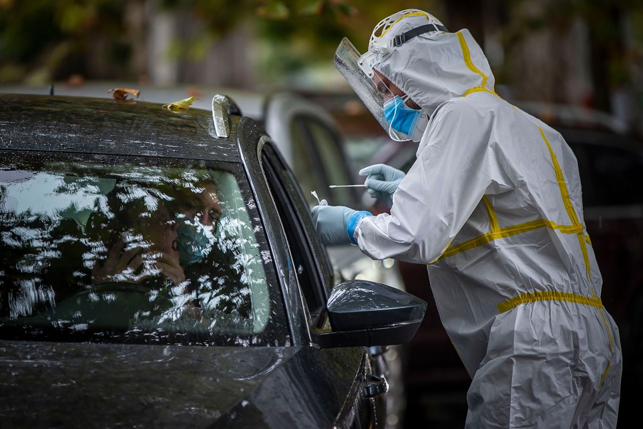 A healthcare worker conducts a Covid-19 test at a drive-in testing station in Prague, Czech Republic, on October 10.