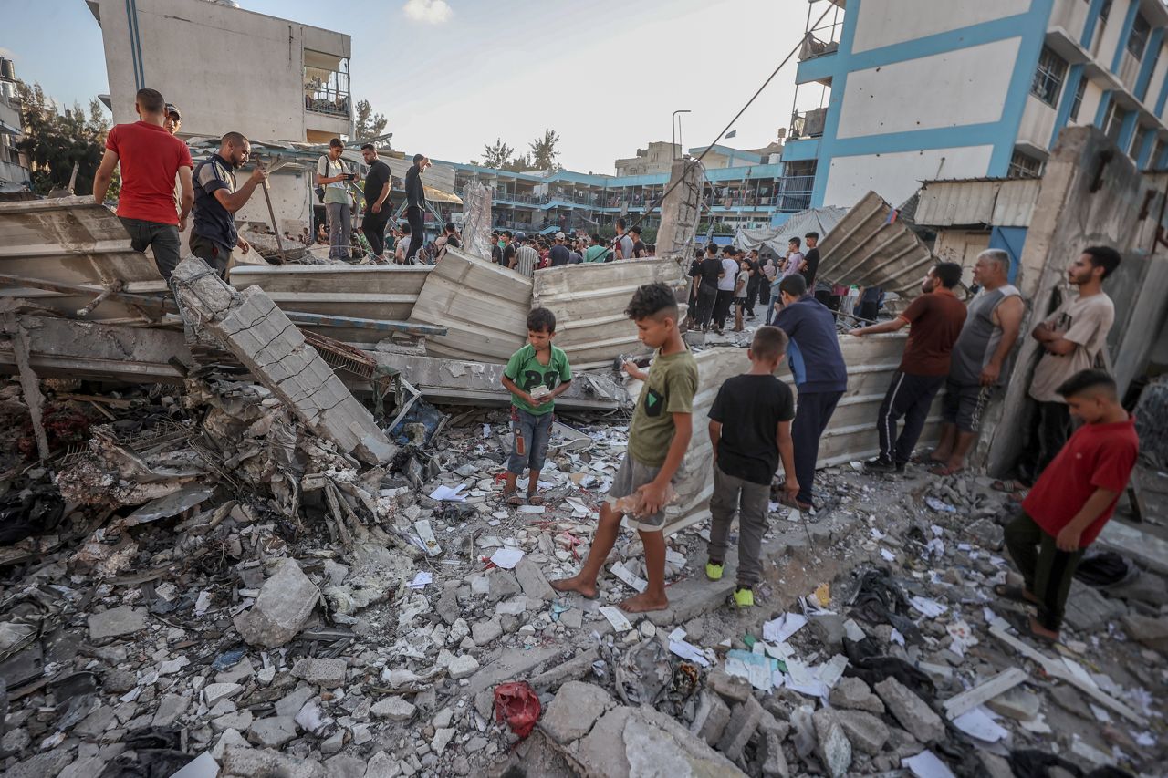 Palestinians inspects the area after Israeli attacks on a school belonging to the UNRWA, which is used as a refugee center in Nuseirat Refugee Camp, Gaza, on July 6.