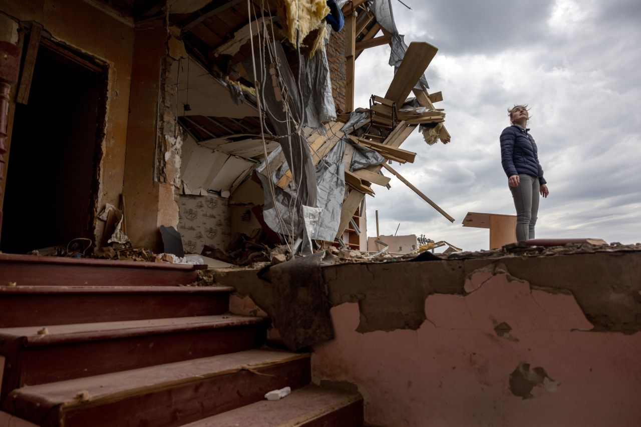 Local resident Oksana surveys the destroyed second floor of her multi-generational home while searching for salvageable items on Monday, April 25, in Hostomel, a suburb of Kyiv.