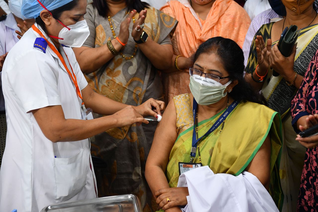 A medical worker inoculates Vidya Thakur, medical dean of the Rajawadi Hospital, with a Covid-19 vaccine at the hospital in Mumbai, India, on January 16.