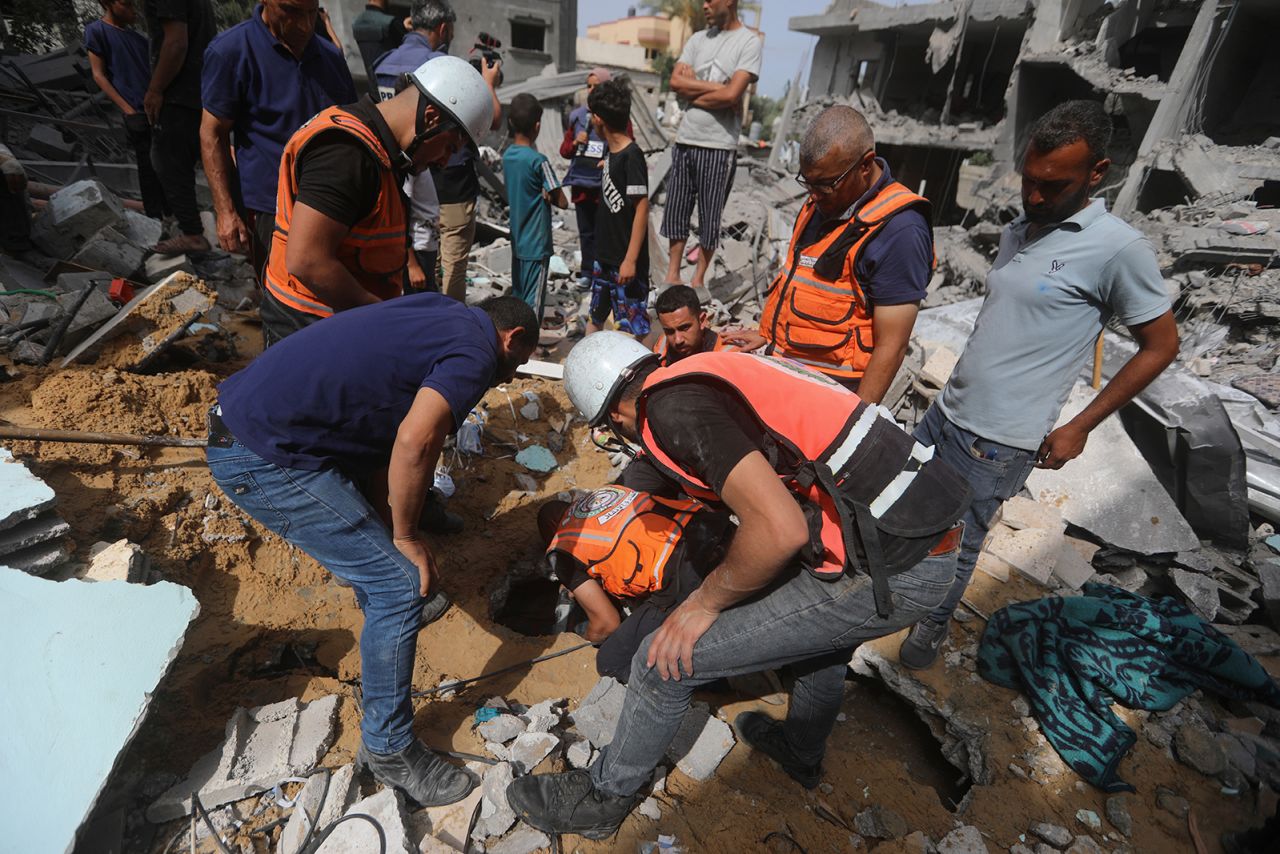 Palestinians search for survivors after an Israeli airstrike on a residential building in Nuseirat Refugee Camp, Gaza Strip, on May 19.