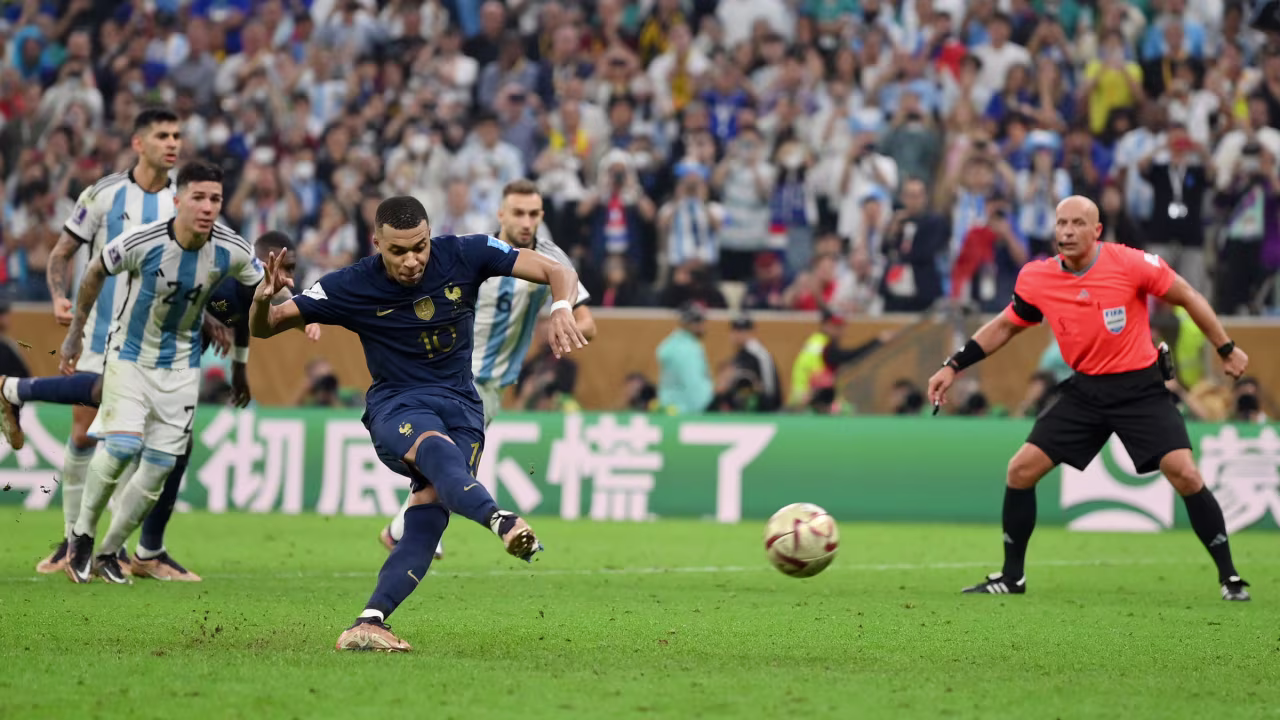 Kylian Mbappe scores his penalty to tie the game at 3-3 in extra time.