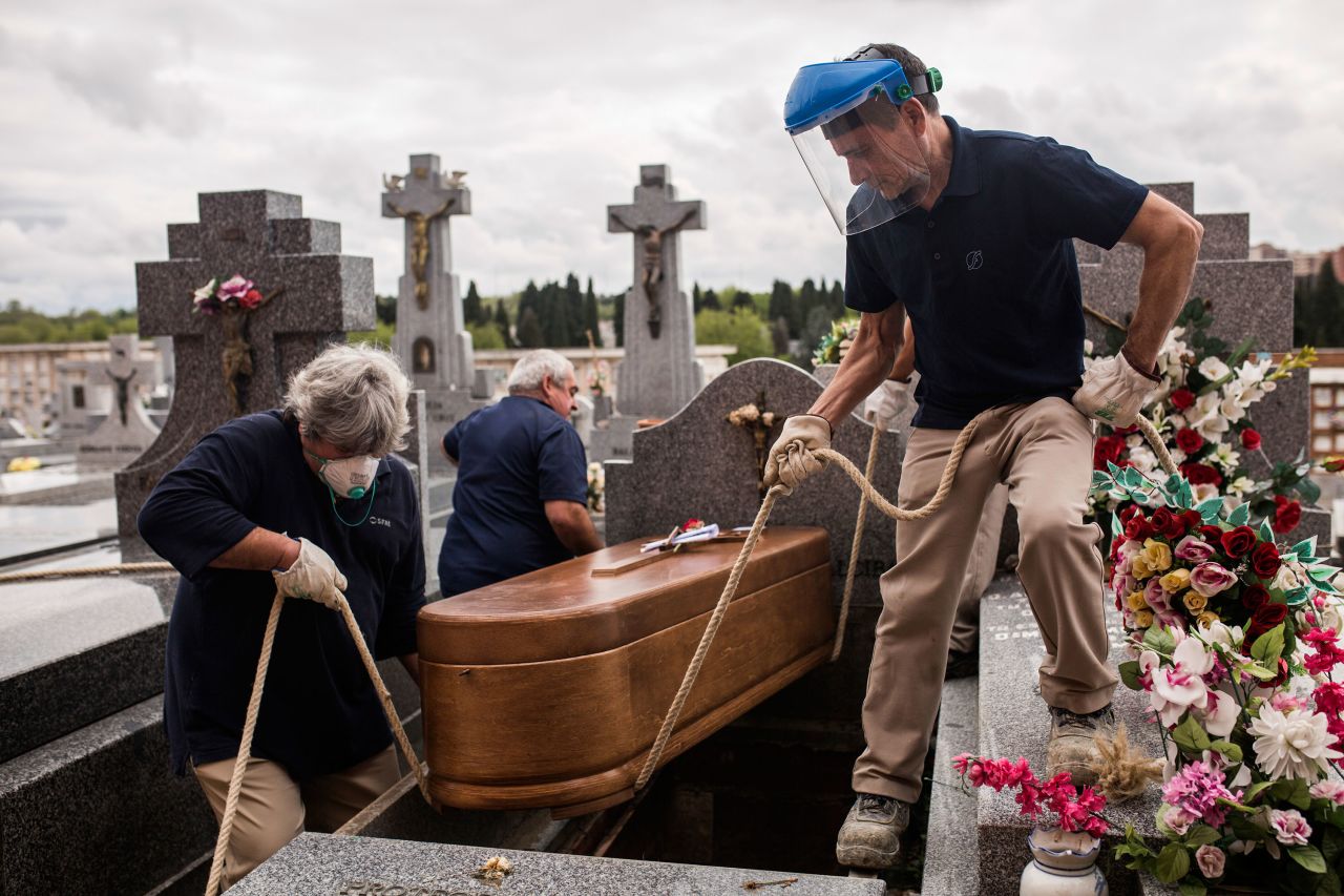 Undertakers lower a coffin at La Almudena cemetery in Madrid, Spain on April 7.