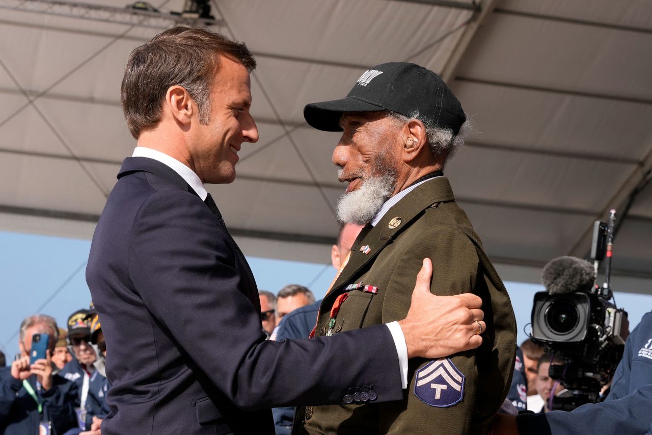 French President Emmanuel Macron awards US WWII veteran Arlester Brown with the Legion of Honor during the International commemorative ceremony at Omaha Beach marking the 80th anniversary of the World War II