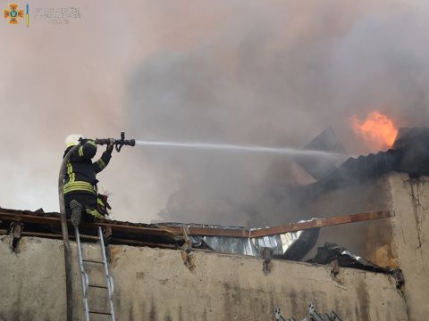 A firefighter works to douse a fire in a building in Mykolaiv, Ukraine, in this handout picture released on July 31.