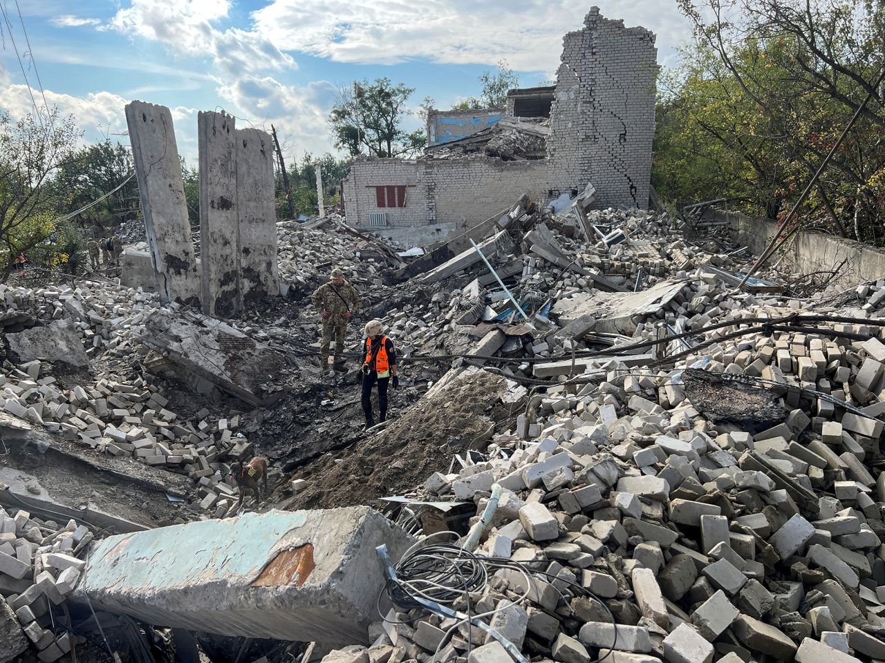 Volunteers search for bodies among the remains of a building in the town of Izium,?Kharkiv?region, Ukraine, on September 26.