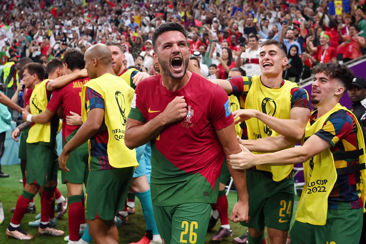 Gonçalo Ramos celebrates with his teammates after scoring the first of his three goals.
