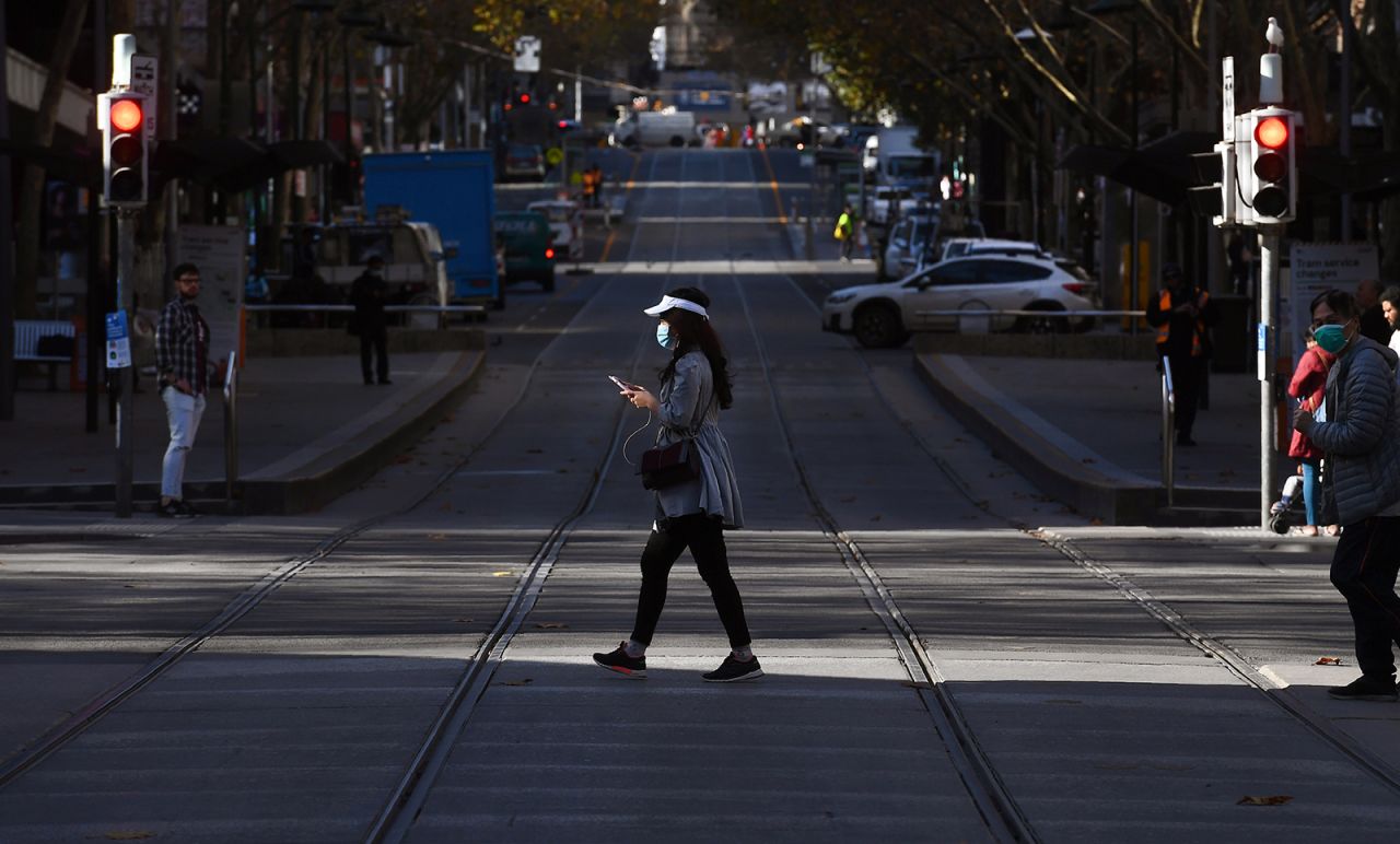 A woman crosses a street in Melbourne's central business district on June 17.