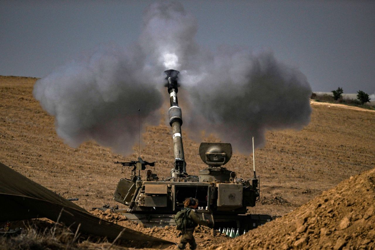 An Israeli army M109 155mm self-propelled howitzer fires rounds toward Gaza from a position in southern Israel on October 28. 