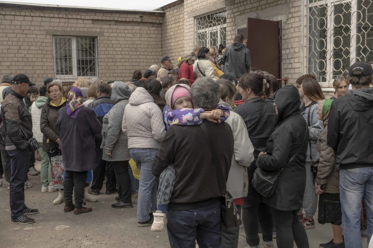 People who have fled from different areas of the Kharkiv region wait in a queue to be registered at an evacuation point in Kharkiv on May 14.