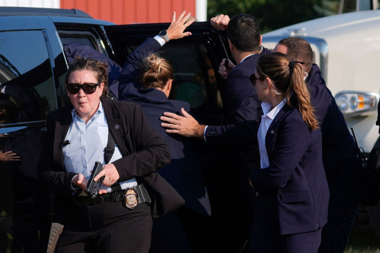 Secret Service agents cover former President Donald Trump at a campaign rally in Butler, Pennsylvania, on July 13. 