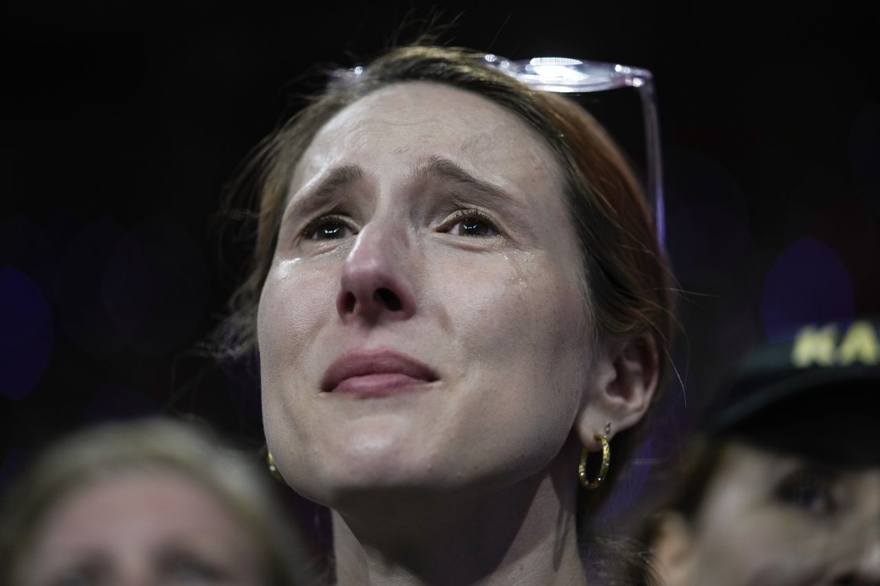 A supporter cries as Harris and Walz arrive on stage.