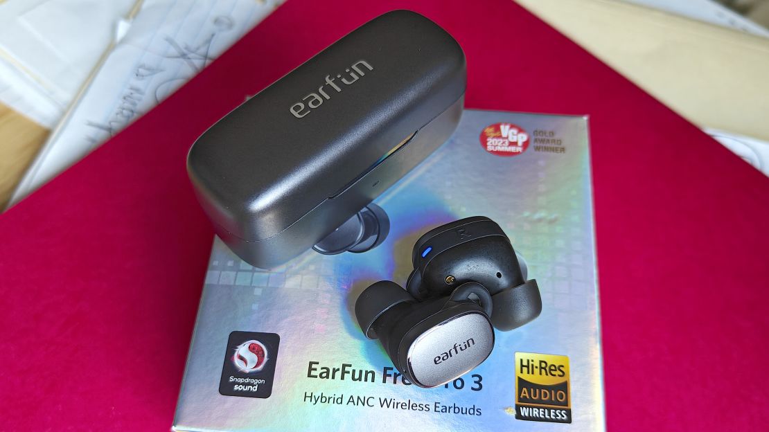 EarFun Free Pro 3 earbuds and case on top of manual.