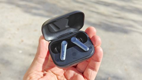 Hand holding the EarFun Air Pro 4 with the case open.