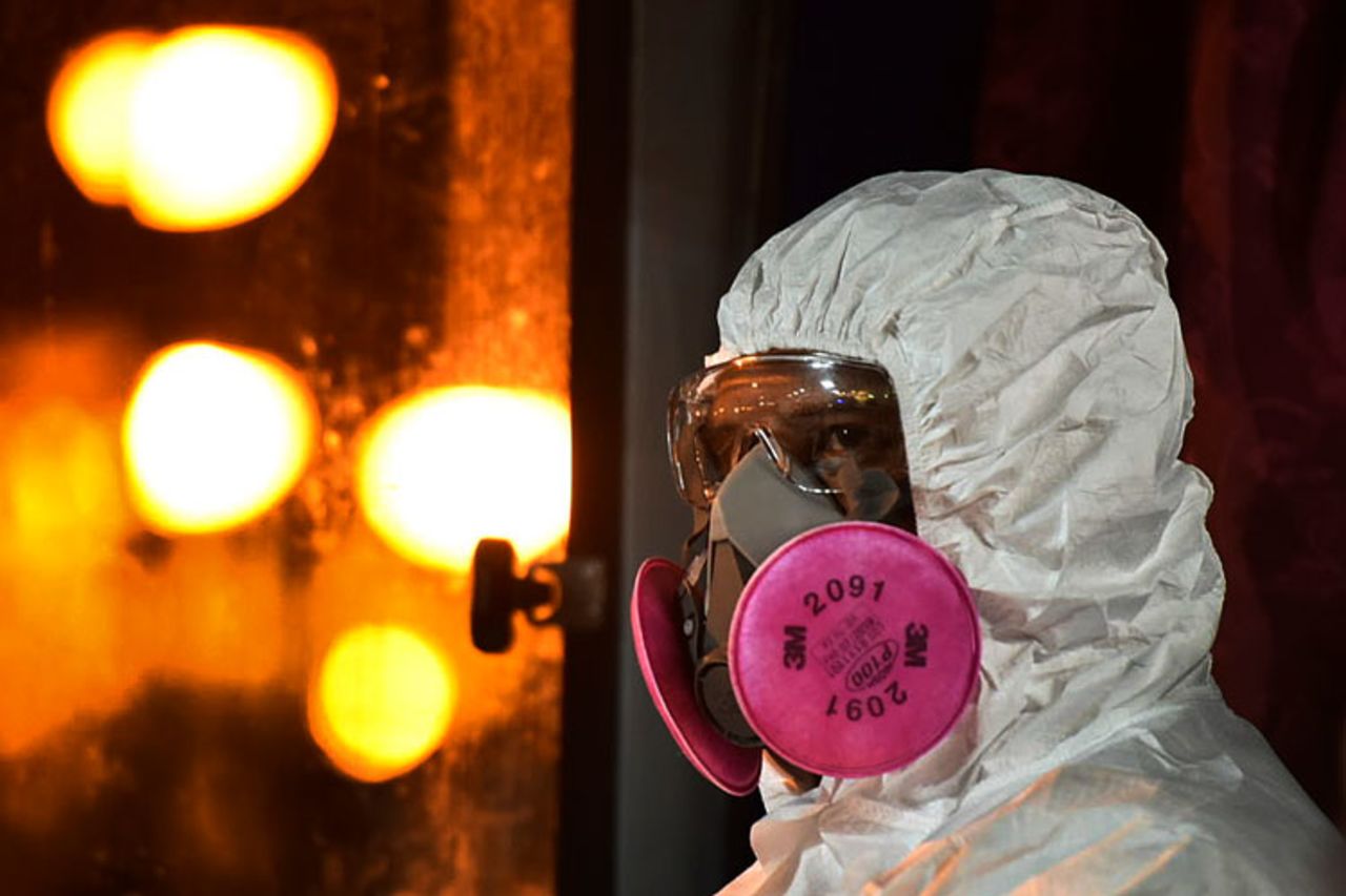 A health worker wearing a full protective suit waits for the arrival of evacuated Malaysians from China's Wuhan at Kuala Lumpur International Airport on February. 26.