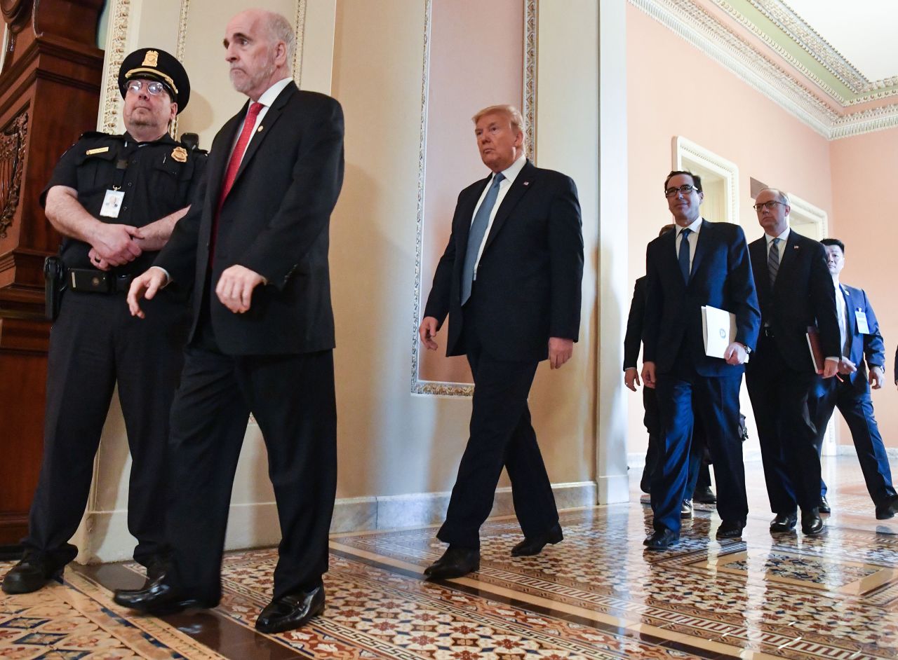 US President Donald Trump walks over to speak with reporters after meeting with Republican Senators on Capitol Hill in Washington, DC on March 10, 2020.?