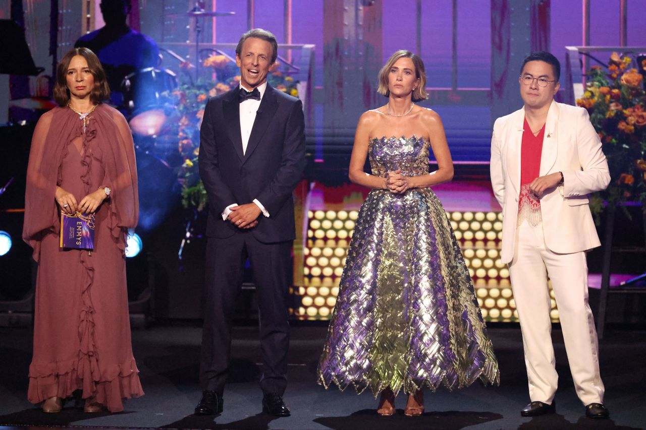 Maya Rudolph, Seth Meyers, Kristen Wiig and Bowen Yang speak onstage. 