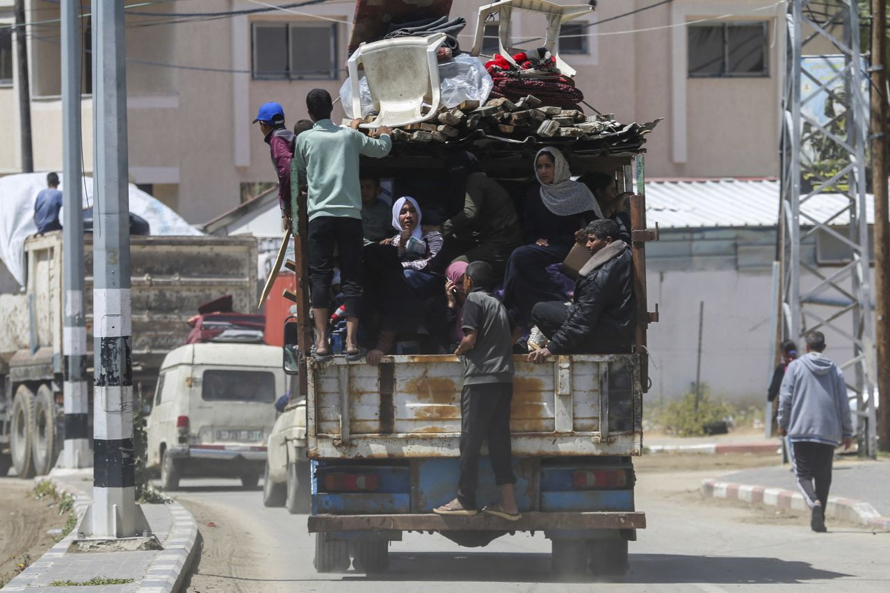 A truck carries people as they flee Rafah. 
